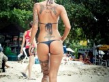 1299552583_hot-bikini-girl-with-sexy-tattoo-on-the-beach-attractive.jpg