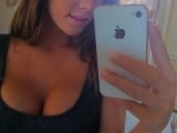 552792-busty-brunette-taking-a-photo-with-her-iphone-in-the-mirror.jpg