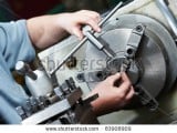 stock-photo-installing-equipment-with-metal-detail-for-operation-on-turning-lathe-machine-with-cutti