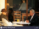 greece-greek-faces-two-old-men-seated-outside-a-coffee-shop-drinking-A5BK2E.jpg