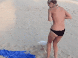 cute-puppy-trying-to-pull-off-girls-bikini-top.gif