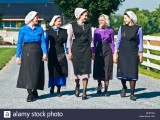 young-amish-women-friends-walking-down-country-lane-road-in-lancaster-BFEPW4.jpg