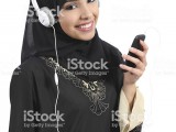 saudi-arab-woman-listening-to-the-music-from-smart-phone-picture-id465247663.jpg