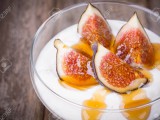 22129490-greek-yogurt-with-figs-and-honey-in-a-glass-bowl-over-old-wood-background.jpg