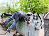 18258973-a-homeless-man-looking-for-food-in-a-garbage-dumpster.jpg