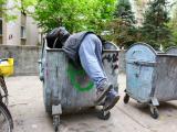 18258966-a-homeless-man-looking-for-food-in-a-garbage-dumpster.jpg